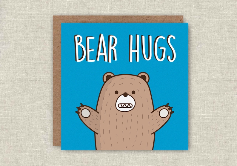 May include: A blue card with the text "BEAR HUGS" in white. A cartoon brown bear with a toothy grin is on the card with its arms outstretched.