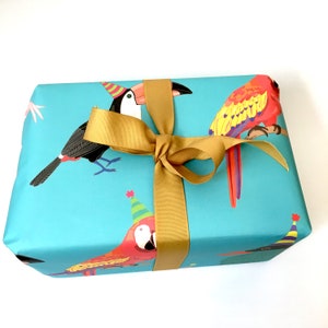 May include: Blue gift wrap with a gold ribbon and a pattern of toucans and parrots wearing party hats.