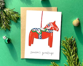 Christmas card, Swedish dala horse, seasons greetings, kitsch, retro Christmas tree decoration, bauble, hand drawn illustration festive card