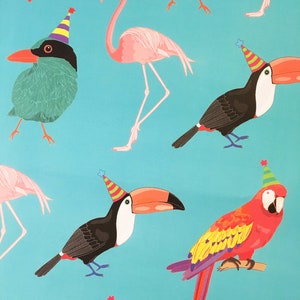 May include: A blue background with a repeating pattern of pink flamingos, green birds, and toucans wearing party hats. The birds are all facing different directions. The flamingos are standing on one leg. The toucans have orange beaks and black and white feathers. The birds are all wearing colourful party hats.