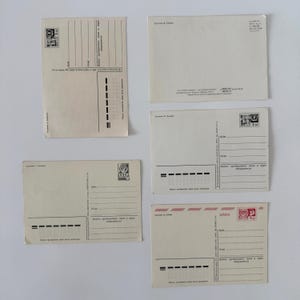 May include: Five vintage postcards from the USSR, each featuring a cream-colored paper back with printed lines for addresses, postal codes, and stamps. The cards include Cyrillic text, various postage markings, and specific artist credits.