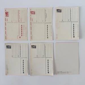 May include: Six rectangular off-white postcards arranged in two rows of three. Each postcard features black printed lines for addresses, postage stamp boxes, and Cyrillic text. Some include red accents and the letters CCCP in the stamp area.