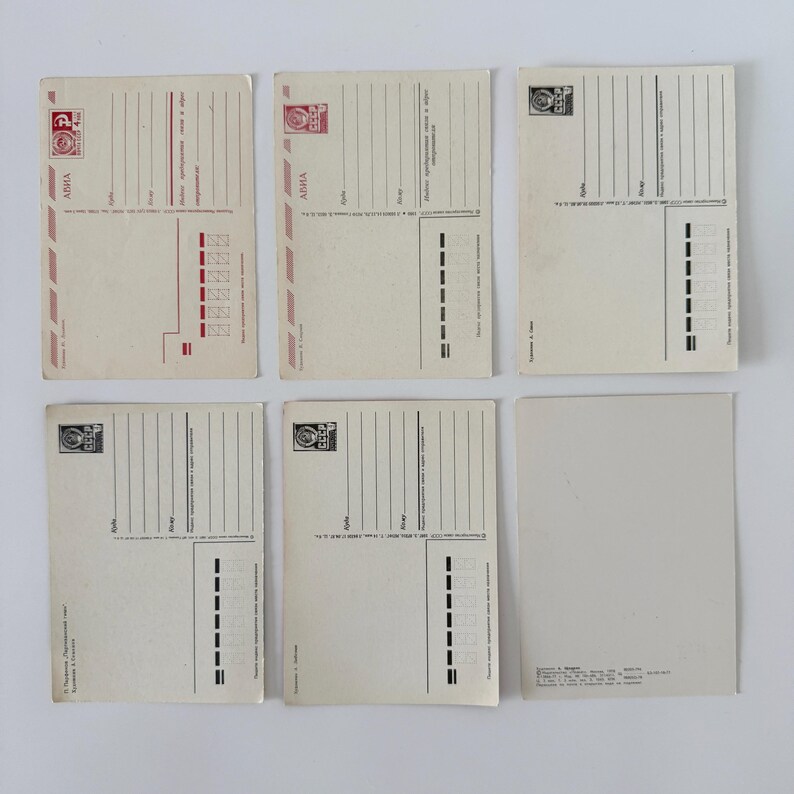 May include: Six rectangular off-white postcards arranged in two rows of three. Each postcard features black printed lines for addresses, postage stamp boxes, and Cyrillic text. Some include red accents and the letters CCCP in the stamp area.