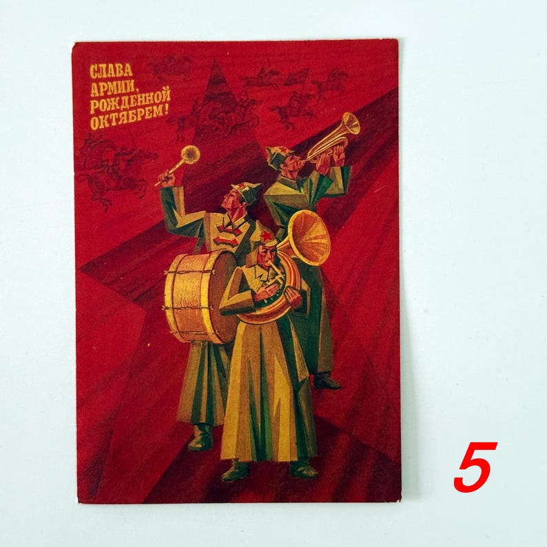 May include: A rectangular vintage postcard featuring a red background with a Soviet-style illustration of three musicians in military uniforms playing a drum, a trumpet, and a horn. The text reads SLAVA ARMII, ROZHDENNOY OKTYABREM in yellow.