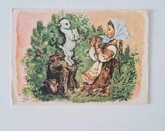 May include: Vintage postcard featuring a colorful illustration of a young person in traditional clothing, interacting with a lamb standing on a tree stump. The background includes lush green foliage and a soft pink sky.
