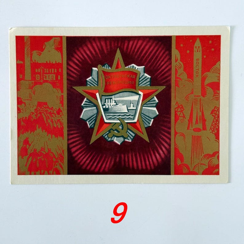 May include: A rectangular postcard featuring a central red star emblem with a ship illustration and the text Oktiabrskaya Revolyutsiya. The left panel shows industrial scenes and figures, while the right panel depicts a Vostok rocket in gold and red.