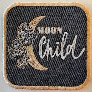 May include: Square patch with a dark grey denim background and a gold border. The patch features a gold crescent moon with floral accents and the words "MOON Child" embroidered in white script.