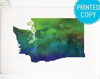 May include: A watercolor painting of the state of Washington in shades of green, blue, and purple. The painting is framed in a white frame and has the text "PRINTED COPY" in a blue circle in the top right corner.
