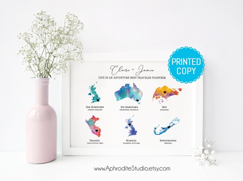 May include: A watercolor print with the text "Claire & Jamie, Life is an adventure best traveled together." The print features watercolor maps of England, Australia, Singapore, Peru, Scotland, and Bermuda with black hearts marking locations.