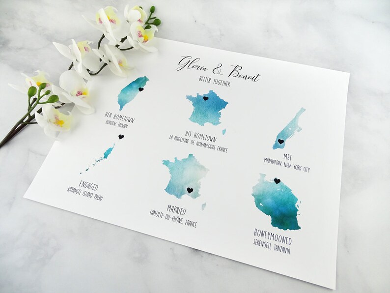 May include: A watercolor map with blue and green hues showing the locations where a couple met, got engaged, married, and honeymooned. The map includes the names of the locations, such as "Manhattan, New York City" and "Serengeti, Tanzania". The text "Gloria & Benoit Better Together" is at the top of the map.