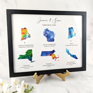 May include: A watercolor print of a couple's love story, featuring maps of their hometowns, where they met, got engaged, married, and honeymooned. The print includes the names Jessica and Susie, and the text "Forever & A Day".