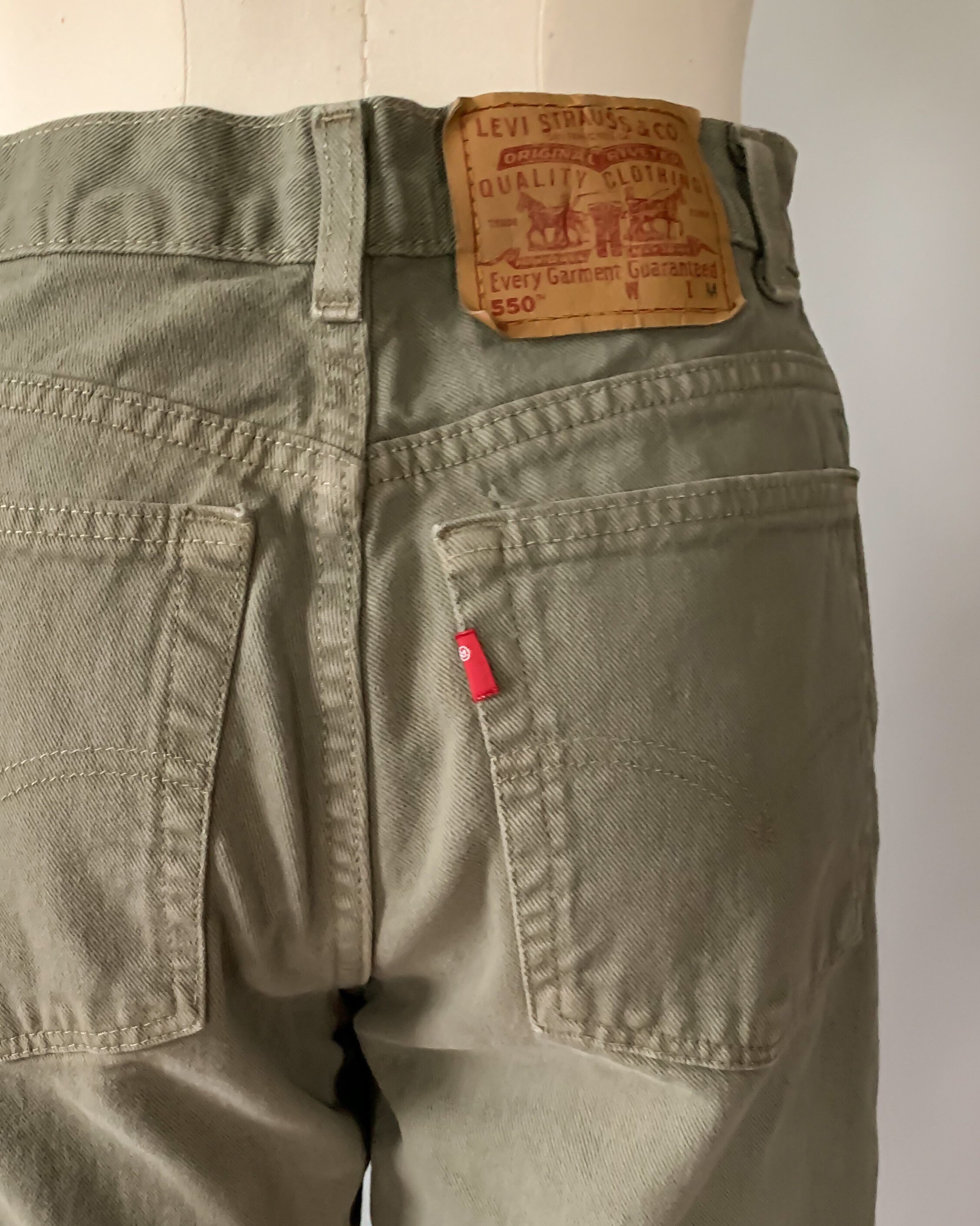 Vintage 1990s Levi's 550 sage olive green jeans / high rise relaxed fit