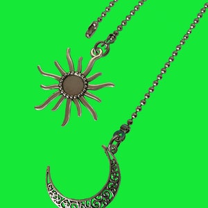 May include: Two silver ceiling fan pull chains with decorative sun and crescent moon charms.