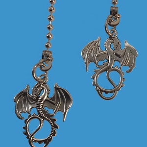 May include: Two silver dragon ceiling fan pull chains. Each chain has a silver dragon with outstretched wings and a curled tail.