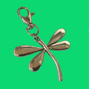 May include: Silver dragonfly keychain with a silver split ring.