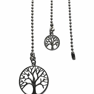 May include: Two silver chains with tree of life pendants. The chains are made of small silver beads. The pendants are round and feature a detailed tree of life design.
