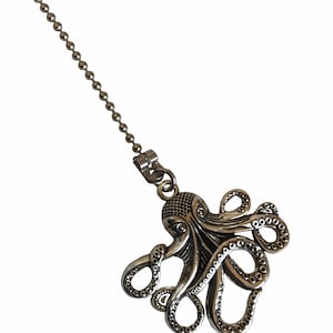 May include: A silver chain with an octopus pendant. The octopus is detailed with textured tentacles and a textured head.