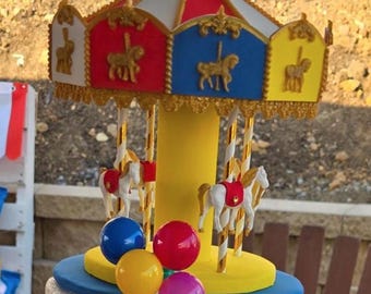 Carousel cake topper faux party prop. Color: red, white, blue, yellow, gold.