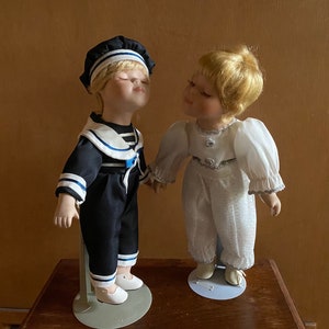 REDUCED Pair of Vintage Dolls “ Kissing Cousins” Bisque Porcelain and Cloth Fabric Collectable Dolls circa 1970s