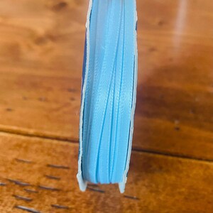 May include: A set of three ceramic vases in varying heights and shapes. The vases feature a matte white finish and a minimalist design, suitable for displaying flowers or as decorative objects. The tallest vase is approximately 10 inches high.