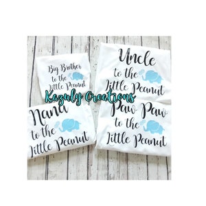 May include: Four white t-shirts with black text and blue elephant graphics. The shirts say "Big Brother to the Little Peanut", "Uncle to the Little Peanut", "Nana to the Little Peanut", and "Paw Paw to the Little Peanut".