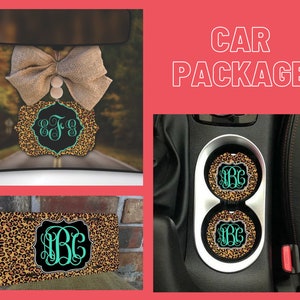 May include: Car package featuring a leopard print design. The package includes a rearview mirror charm, two cup coasters, and a license plate frame. All items feature a monogram with the initials "B.G." in a teal colour.