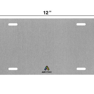 May include: A grey metal licence plate with rounded corners and two holes on each side. The plate is 12 inches wide and 9 inches tall. The text "AIRSTRIKE" is printed in black at the bottom of the plate.