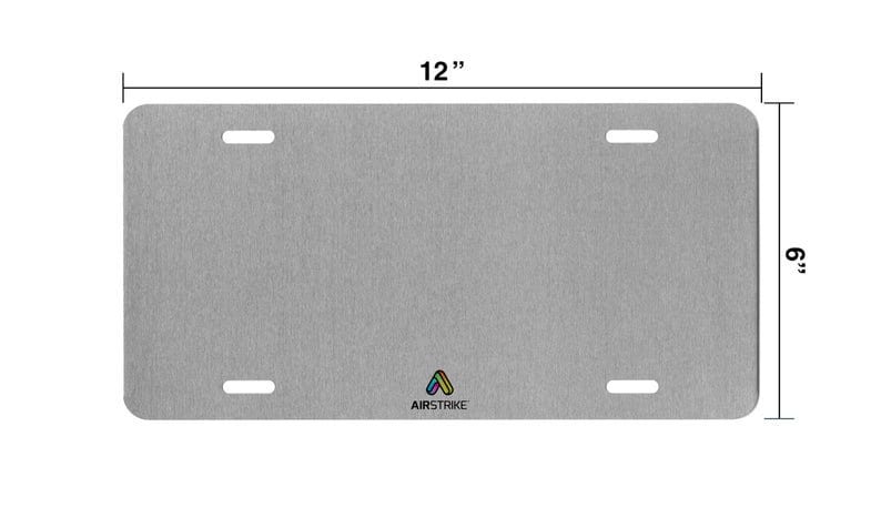May include: A grey metal licence plate with rounded corners and two holes on each side. The plate is 12 inches wide and 9 inches tall. The text "AIRSTRIKE" is printed in black at the bottom of the plate.