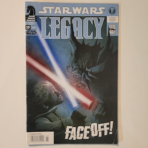 May include: A Star Wars Legacy comic book cover featuring a blue and red lightsaber duel between a human and a monstrous alien. The cover text reads "Star Wars Legacy" and "Face Off!"