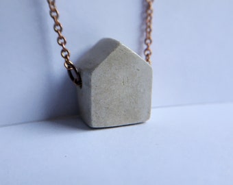 House (in the middle of the street). Handmade clay pendant necklace.