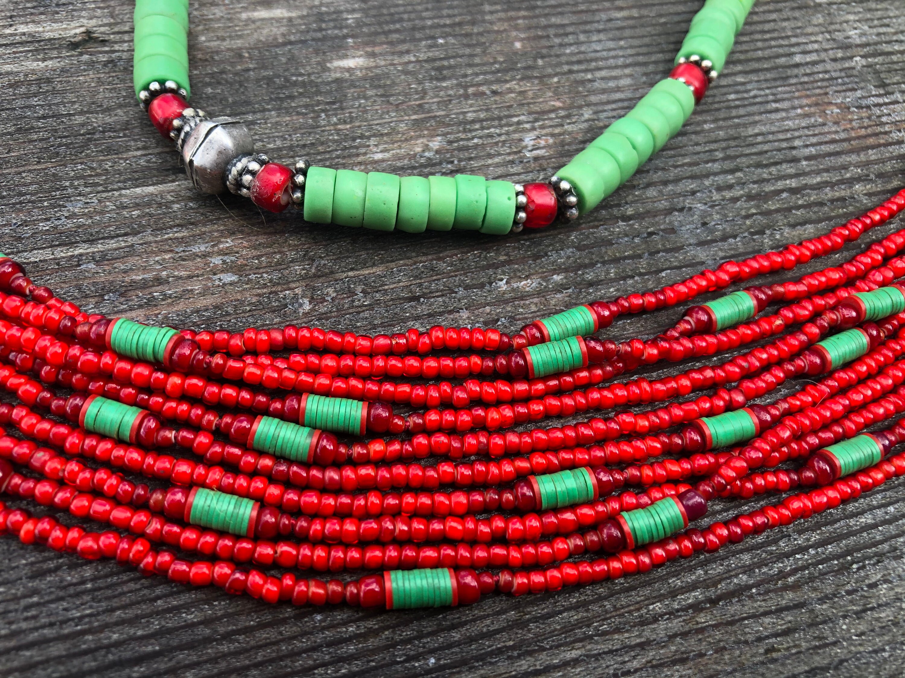 Single strand necklace of Pistachio Green Java French Cross Beads, mixed  with antique, beautiful Venetian red skunk trade beads, Ethiopian etched  metal beads, and bone beads.
