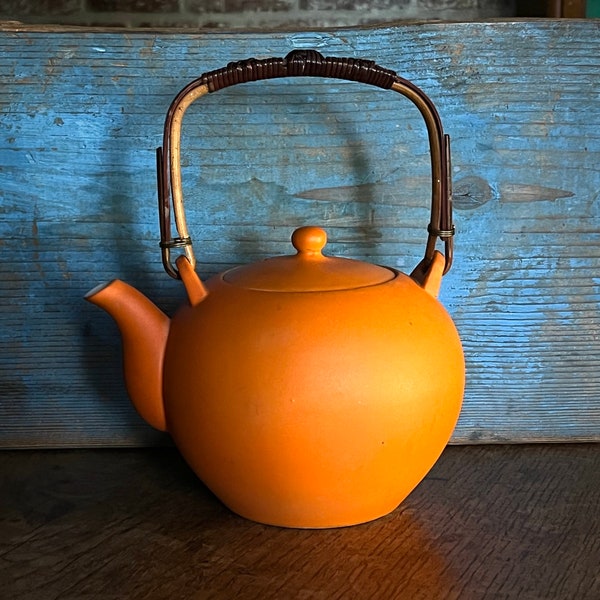 Round, orange, porcelain teapot with wrapped bamboo handle - similar to Kenji Fujita for Tackett Associates