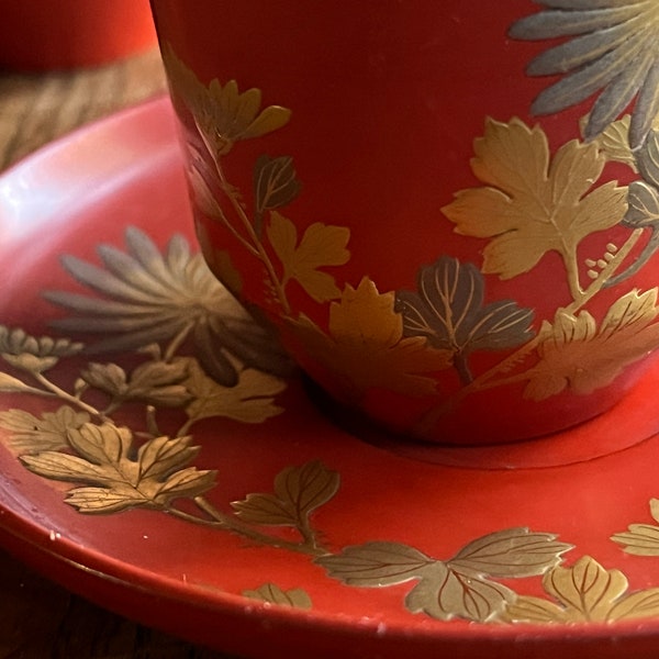 Set of 5 antique Japanese lacquer demitasse cups and saucers. Each different. In red, gold and silver