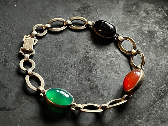 JMK gilt silver link bracelet with bezel set stones.