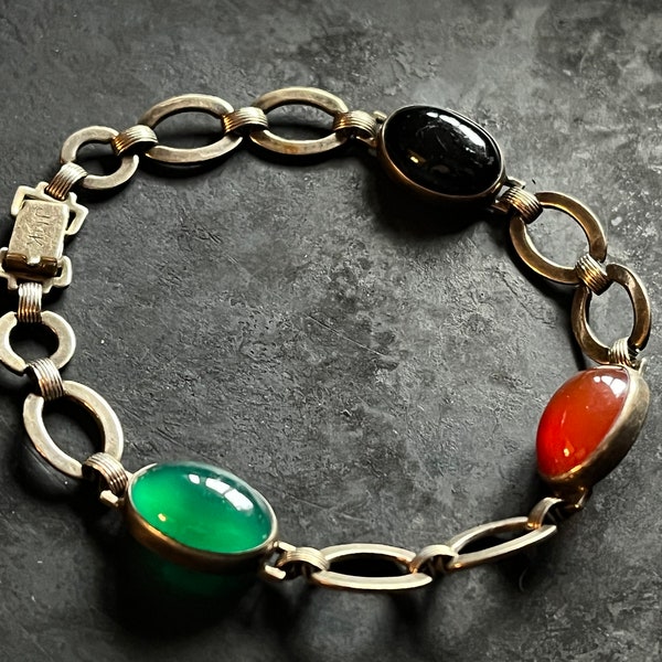 JMK gilt silver link bracelet with bezel set stones.