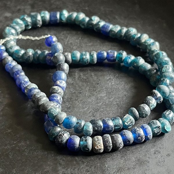 Strand of ancient, deep blue to aqua Indo-Pacific, trade wind glass beads.