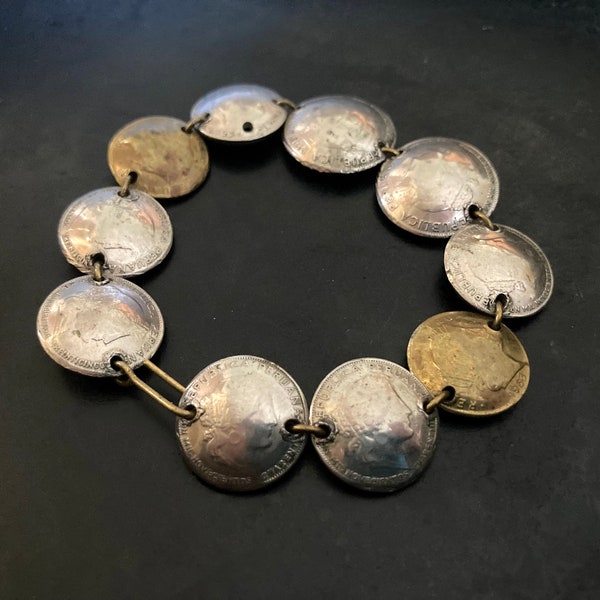 Bracelet of linked, domed, Peruvian Centavo coins in brass and nickel silver.