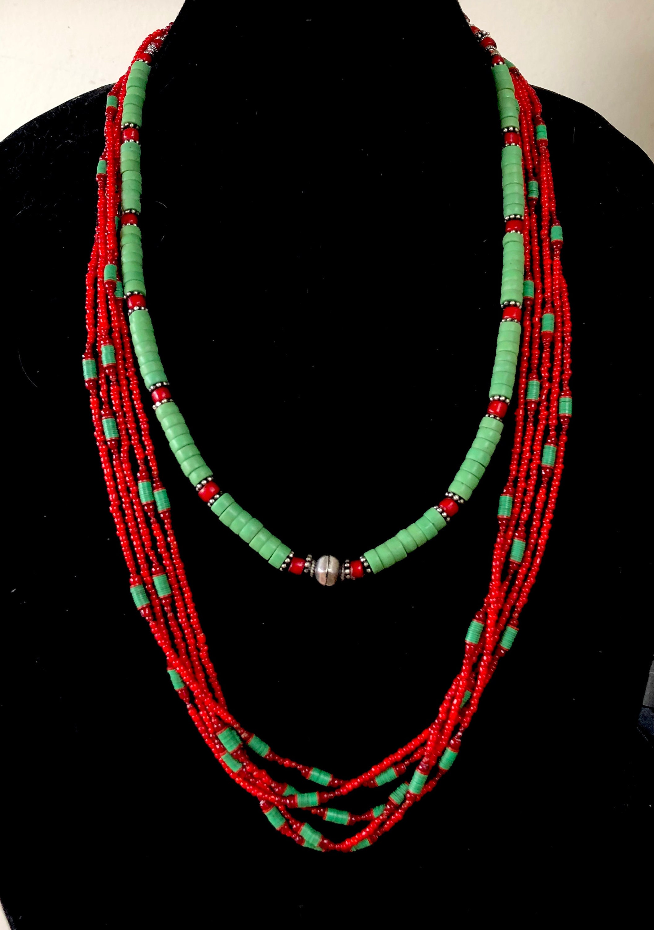 Single strand necklace of Pistachio Green Java French Cross Beads, mixed  with antique, beautiful Venetian red skunk trade beads, Ethiopian etched  metal beads, and bone beads.