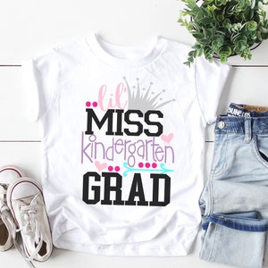 white tshirt with little miss kindergarten grad design in pink and purple with crown