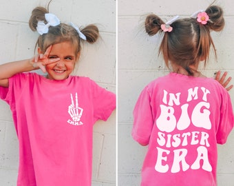 Girls Comfort Colors® T-Shirt - 'In My Big Sister Era' Back Print - Personalized Front Pocket Print with Trendy Skeleton Peace Sign and Name