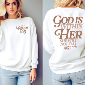May include: White sweatshirt with the text "God is within her, she will not fall, Psalm 46:5" printed on the back in brown and pink lettering.