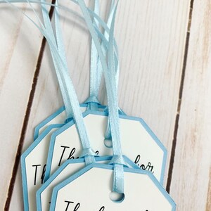 Peter Rabbit "Thank you for hopping by" birthday or baby shower party favor tags. The color of Peter Rabbit's jacket is customizable and can be changed from blue to pink, green or yellow. The background and ribbon will coordinate with Peter Rabbit's Jacket. The text is also customizable.