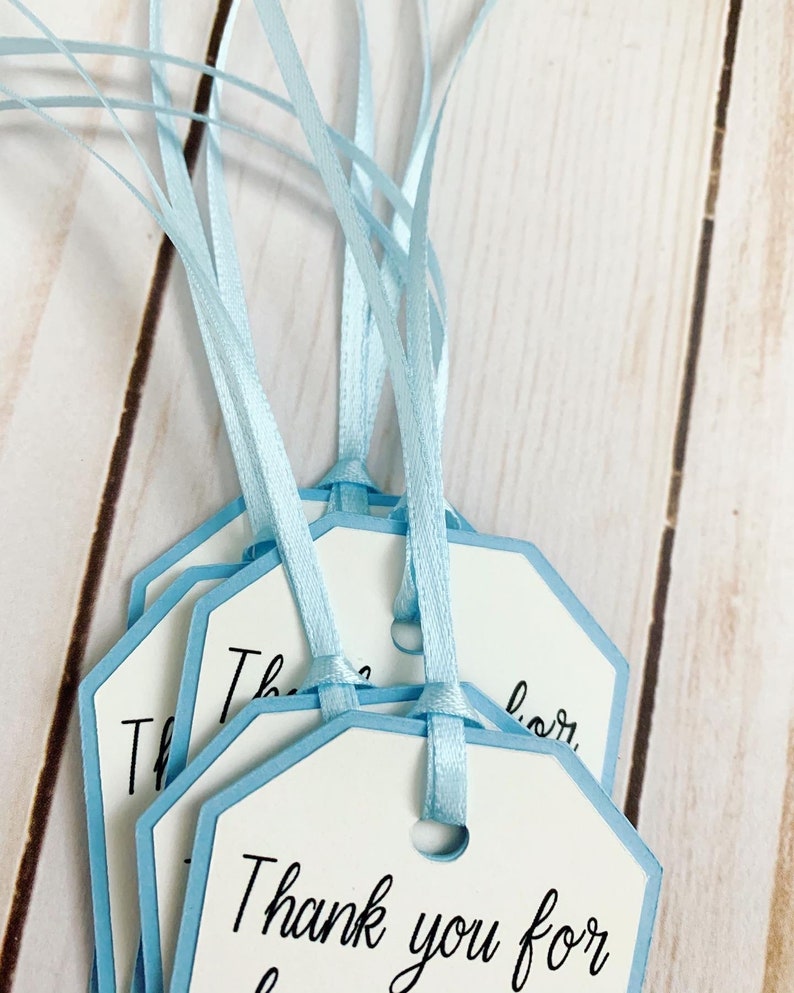 Peter Rabbit "Thank you for hopping by" birthday or baby shower party favor tags. The color of Peter Rabbit's jacket is customizable and can be changed from blue to pink, green or yellow. The background and ribbon will coordinate with Peter Rabbit's Jacket. The text is also customizable.