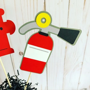 firefighter centerpiece birthday decorations featuring a firetruck, emblem with age, flame, fire hydrant, dalmatian and fire extinguisher