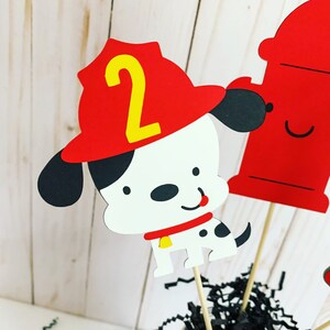 firefighter centerpiece birthday decorations featuring a firetruck, emblem with age, flame, fire hydrant, dalmatian and fire extinguisher