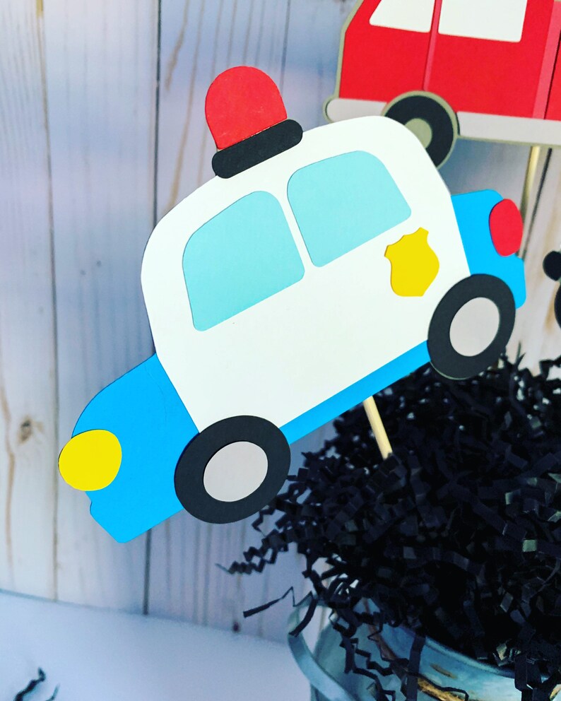 first responders emergency vehicles birthday party or baby shower centerpiece table decorations that include a firetruck, ambulance and police car