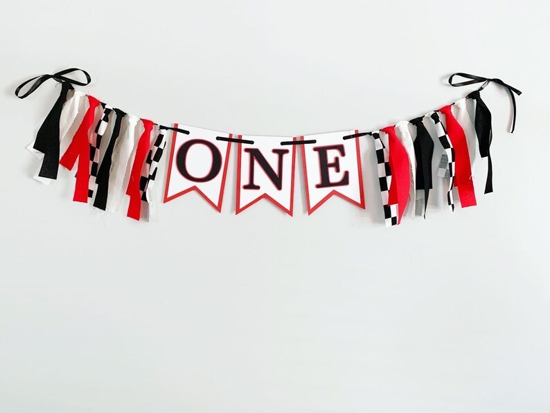red, white and black racing themed high chair one banner featuring checkered flag fabric