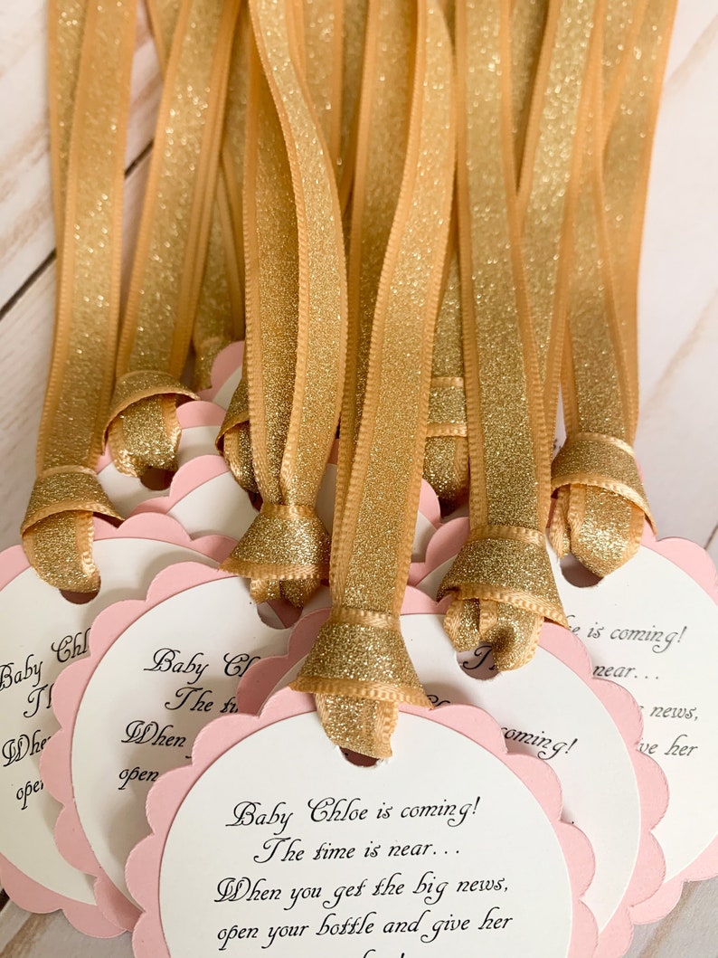 pink and gold baby shower favor tags for mini champagne bottles