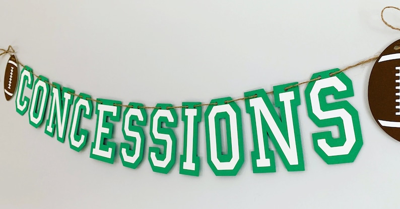football concessions banner featuring varsity letters and two footballs that will be perfect for your little one's football themed birthday party, super bowl game day party, sports team party or to hang on your schools concession stand during football season. The banner is fully customizable.