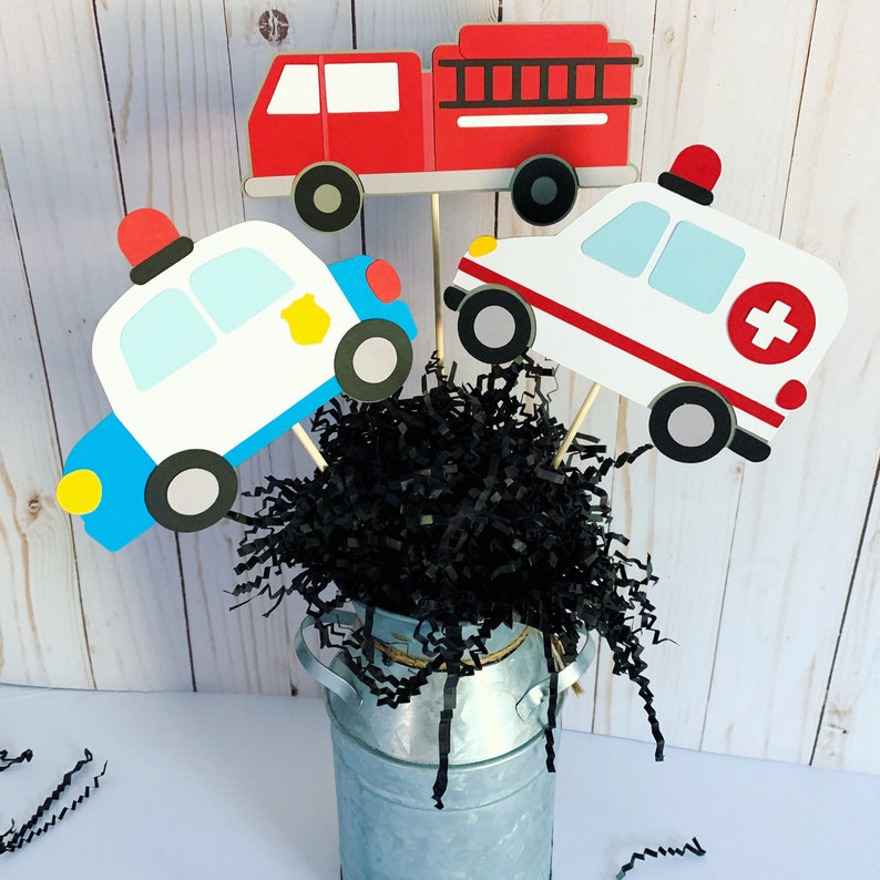 first responders emergency vehicles birthday party or baby shower centerpiece table decorations that include a firetruck, ambulance and police car